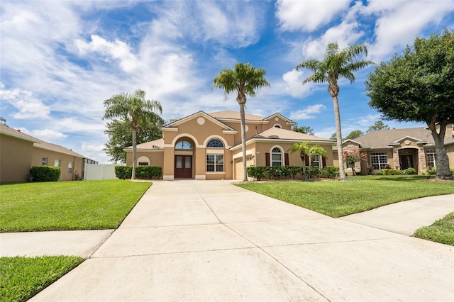 4548 Barrister Dr, Clermont, FL 34711 - mediterranean / spanish-style home with driveway, stucco siding, a front lawn, and an attached garage