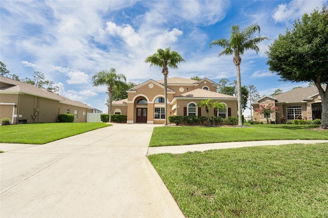 4548 Barrister Dr, Clermont, FL 34711 - mediterranean / spanish-style house with a front lawn, stucco siding, and concrete driveway