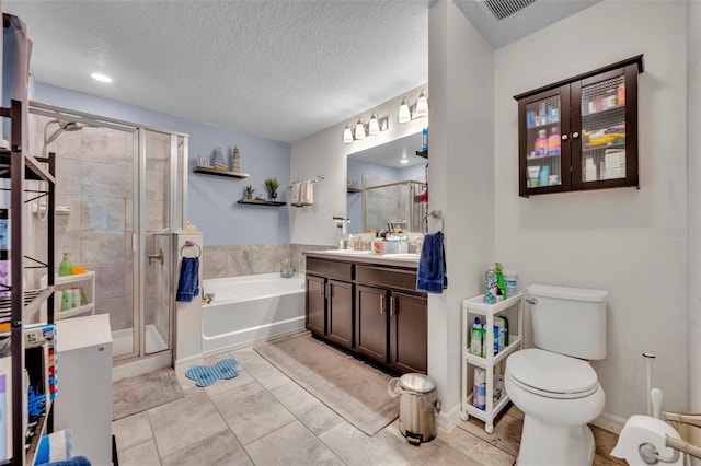 2488 Begonia St, Mascotte, FL 34753 - full bath with vanity, a stall shower, a bath, a textured ceiling, and tile patterned flooring