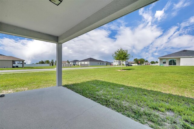 2488 Begonia St, Mascotte, FL 34753 - view of green lawn featuring a patio area and a residential view