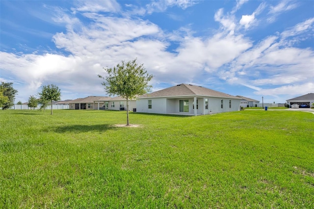 2488 Begonia St, Mascotte, FL 34753 - rear view of property with a yard and stucco siding
