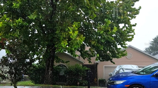 1055 Bluegrass Dr, Groveland, FL 34736 - view of front of home featuring an attached garage