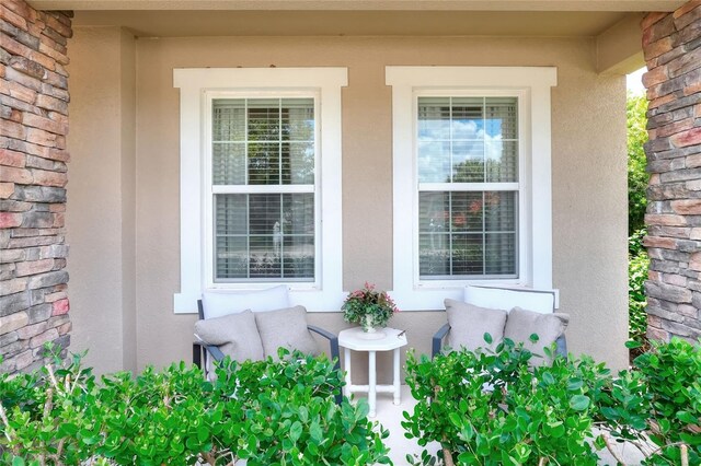 6906 Glenbrook Dr, Lakeland, FL 33811 - view of exterior entry with covered porch and stucco siding