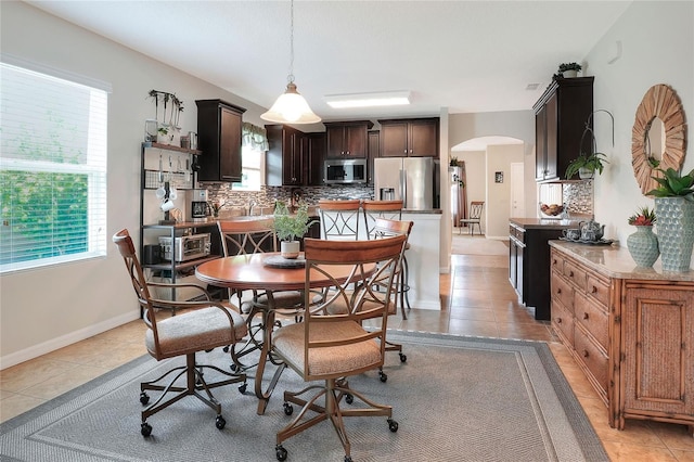 6906 Glenbrook Dr, Lakeland, FL 33811 - dining area featuring arched walkways, plenty of natural light, and light tile patterned floors