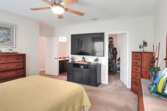 6906 Glenbrook Dr, Lakeland, FL 33811 - bedroom featuring a spacious closet, light carpet, ensuite bathroom, a closet, and ceiling fan