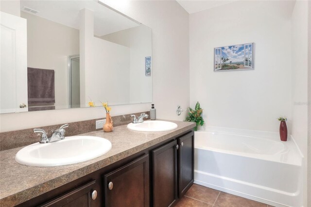 6906 Glenbrook Dr, Lakeland, FL 33811 - bathroom with double vanity, a garden tub, and tile patterned floors