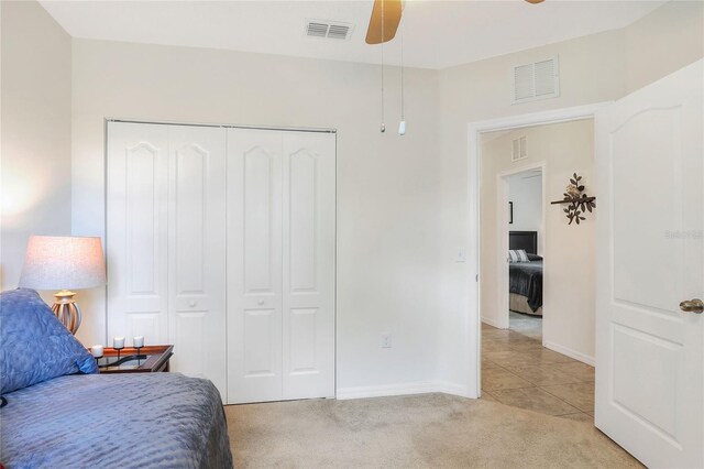 6906 Glenbrook Dr, Lakeland, FL 33811 - bedroom featuring light colored carpet, a closet, light tile patterned floors, and a ceiling fan
