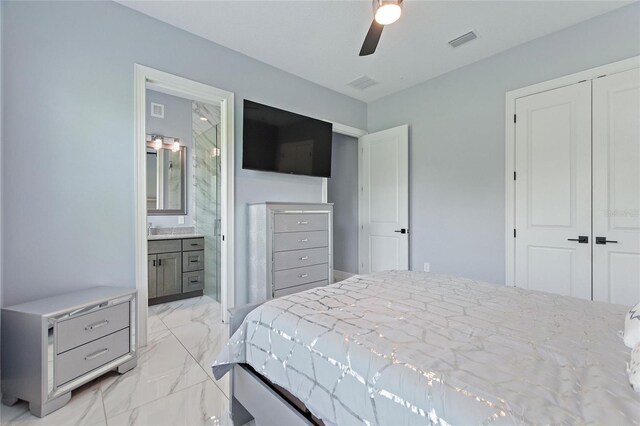 1702 Hidden Palms Dr, Davenport, FL 33897 - bedroom featuring light marble finish flooring, a closet, a ceiling fan, and ensuite bath