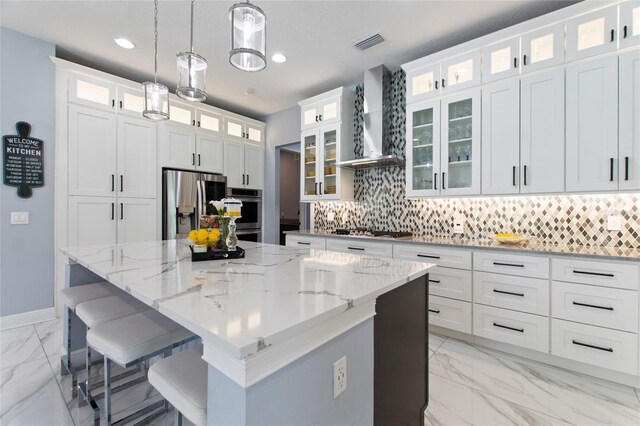 1702 Hidden Palms Dr, Davenport, FL 33897 - kitchen with light marble finish floors, stainless steel appliances, a center island, decorative backsplash, and recessed lighting