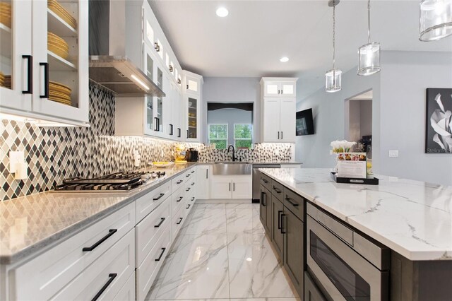 1702 Hidden Palms Dr, Davenport, FL 33897 - kitchen featuring wall chimney exhaust hood, stainless steel appliances, recessed lighting, decorative backsplash, and white cabinetry