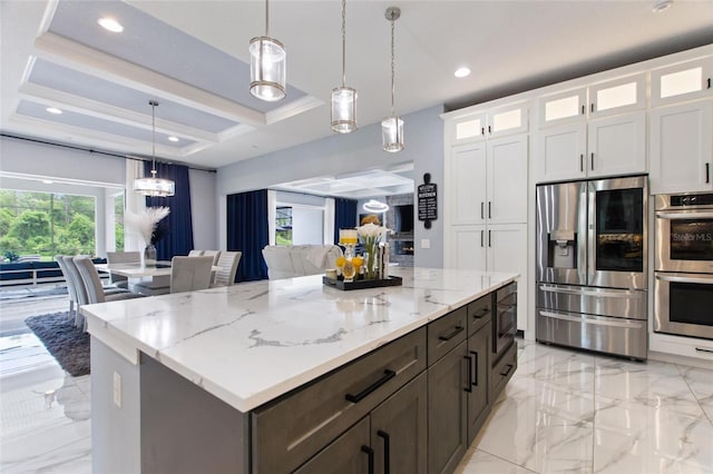 1702 Hidden Palms Dr, Davenport, FL 33897 - kitchen with stainless steel appliances, coffered ceiling, light marble finish flooring, white cabinetry, and decorative light fixtures