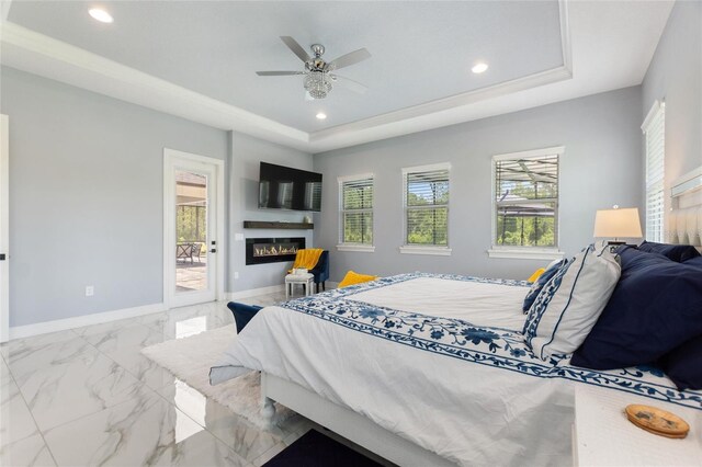 1702 Hidden Palms Dr, Davenport, FL 33897 - bedroom with a tray ceiling, marble finish floors, access to exterior, a glass covered fireplace, and recessed lighting