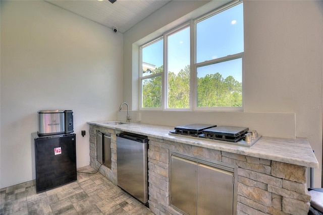 1702 Hidden Palms Dr, Davenport, FL 33897 - kitchen with stainless steel appliances, light stone counters, and vaulted ceiling