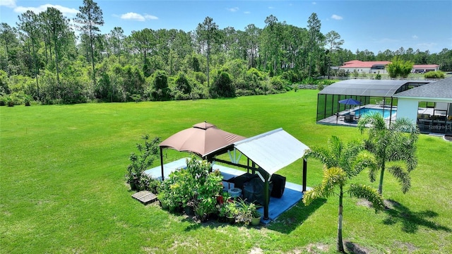 1702 Hidden Palms Dr, Davenport, FL 33897 - view of green lawn with glass enclosure, a gazebo, and an outdoor pool