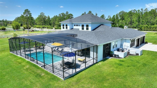 1702 Hidden Palms Dr, Davenport, FL 33897 - swimming pool featuring a patio, a lawn, glass enclosure, a hot tub, and view of wooded area