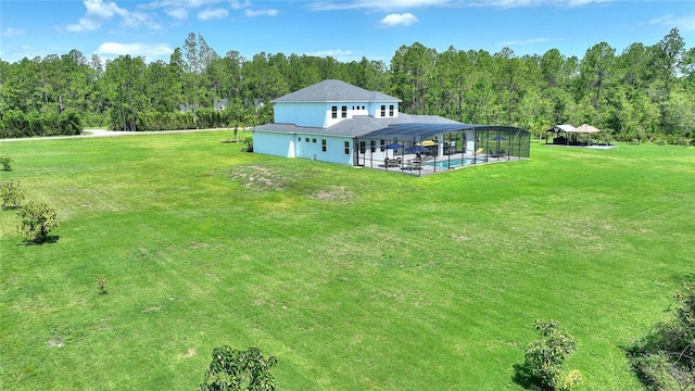 1702 Hidden Palms Dr, Davenport, FL 33897 - back of property featuring an outdoor pool, a lawn, a view of trees, and glass enclosure