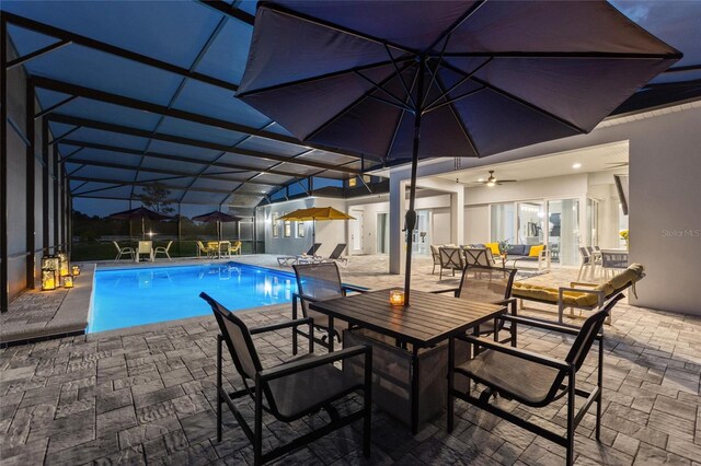 1702 Hidden Palms Dr, Davenport, FL 33897 - outdoor pool featuring a patio, an outdoor living space, outdoor dining space, and glass enclosure