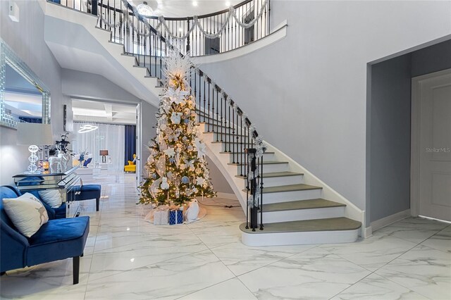 1702 Hidden Palms Dr, Davenport, FL 33897 - stairs featuring a high ceiling, marble finish flooring, and a chandelier