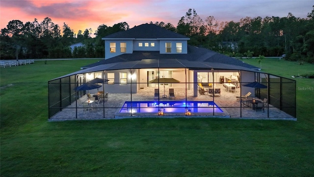 1702 Hidden Palms Dr, Davenport, FL 33897 - back of property at dusk featuring a patio, a yard, an outdoor pool, and outdoor dining space
