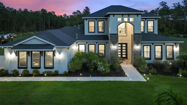 1702 Hidden Palms Dr, Davenport, FL 33897 - view of front of property with stucco siding, a shingled roof, and a front lawn