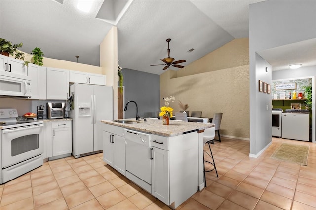 3184 Maltby Dr, Deltona, FL 32738 - kitchen with white appliances, lofted ceiling, ceiling fan, white cabinets, and a center island with sink