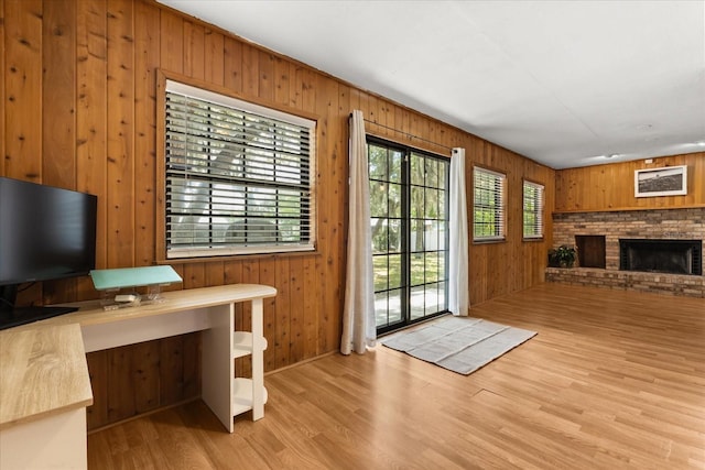 3184 Maltby Dr, Deltona, FL 32738 - doorway to outside with wooden walls, wood finished floors, and a fireplace