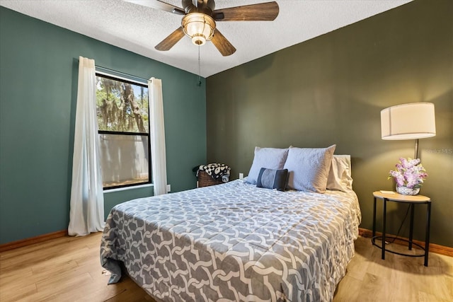 3184 Maltby Dr, Deltona, FL 32738 - bedroom with wood finished floors, a textured ceiling, and a ceiling fan