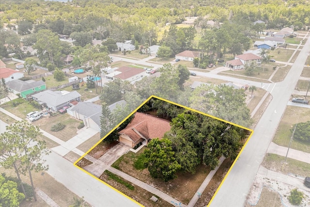 3184 Maltby Dr, Deltona, FL 32738 - aerial perspective of suburban area featuring property parcel outlined and a heavily wooded area