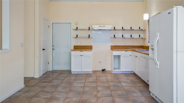 15925 Summit Ct, Clermont, FL 34711 - kitchen with white appliances, open shelves, white cabinets, and butcher block countertops