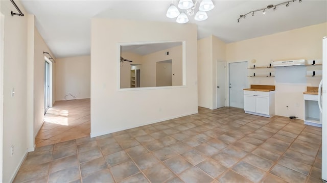 15925 Summit Ct, Clermont, FL 34711 - kitchen with a chandelier, white cabinets, and under cabinet range hood