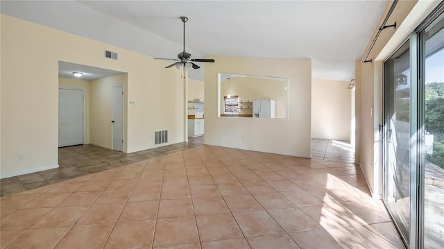 15925 Summit Ct, Clermont, FL 34711 - spare room featuring vaulted ceiling, ceiling fan, and light tile patterned floors