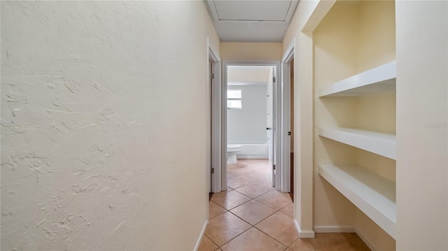 15925 Summit Ct, Clermont, FL 34711 - hallway with light tile patterned flooring, a textured wall, and built in features