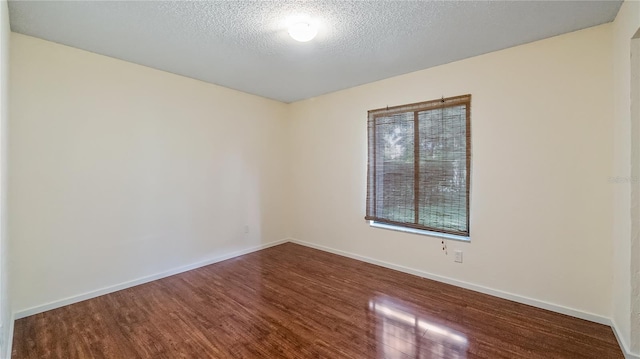 15925 Summit Ct, Clermont, FL 34711 - spare room with wood finished floors and a textured ceiling