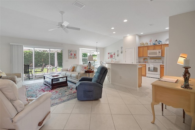 2369 Unity Ter, The Villages, FL 32162 - living area with a ceiling fan, healthy amount of natural light, light tile patterned floors, vaulted ceiling, and recessed lighting