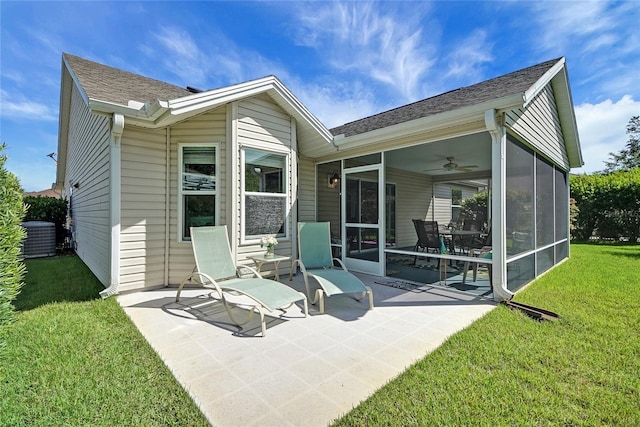 2369 Unity Ter, The Villages, FL 32162 - back of property with a sunroom, a yard, a patio, a ceiling fan, and a shingled roof