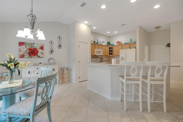 2369 Unity Ter, The Villages, FL 32162 - kitchen with white appliances, a chandelier, light countertops, glass insert cabinets, and light tile patterned floors
