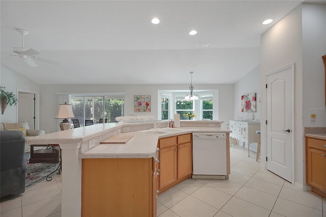 2369 Unity Ter, The Villages, FL 32162 - kitchen featuring white dishwasher, lofted ceiling, healthy amount of natural light, open floor plan, and light countertops