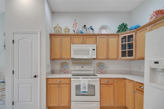 2369 Unity Ter, The Villages, FL 32162 - kitchen featuring white appliances, light countertops, and glass insert cabinets