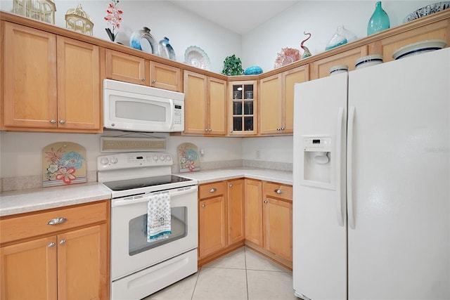 2369 Unity Ter, The Villages, FL 32162 - kitchen featuring white appliances, light countertops, glass insert cabinets, and light tile patterned floors
