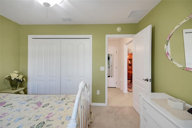 2369 Unity Ter, The Villages, FL 32162 - bedroom featuring light tile patterned flooring, a closet, and light carpet