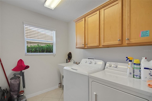 2369 Unity Ter, The Villages, FL 32162 - laundry area with washer and dryer, cabinet space, and light tile patterned flooring