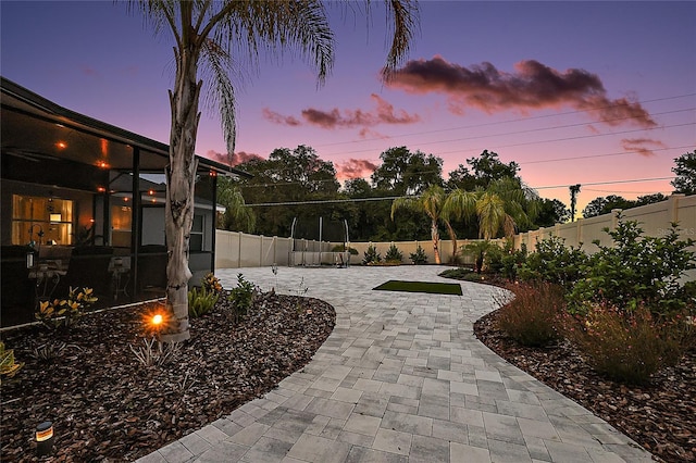 318 Stone Castle Loop, Lady Lake, FL 32159 - fenced backyard featuring a patio area and decorative driveway