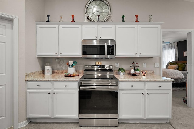 318 Stone Castle Loop, Lady Lake, FL 32159 - kitchen with appliances with stainless steel finishes and white cabinetry