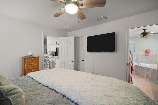 318 Stone Castle Loop, Lady Lake, FL 32159 - tiled bedroom with a ceiling fan and ensuite bath