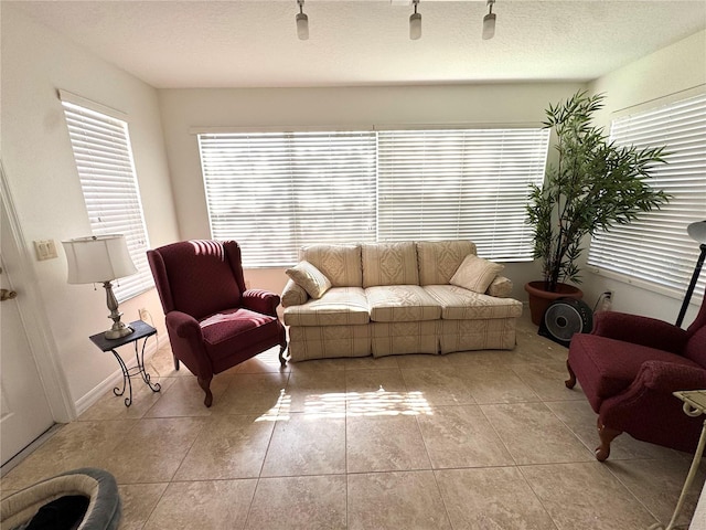 17483 SE 74th Netherclift Ter, The Villages, FL 32162 - living room featuring light tile patterned flooring and a textured ceiling