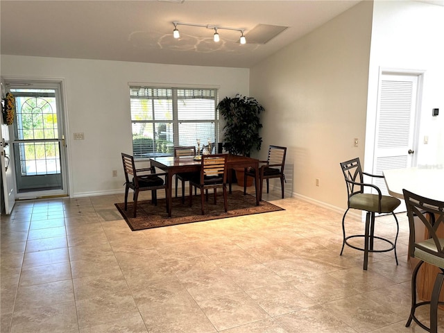 17483 SE 74th Netherclift Ter, The Villages, FL 32162 - dining space featuring light tile patterned floors and rail lighting