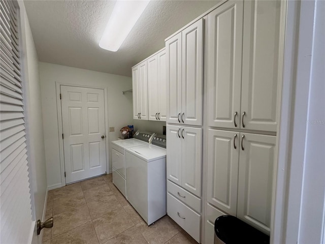 17483 SE 74th Netherclift Ter, The Villages, FL 32162 - washroom with cabinet space, washer and clothes dryer, light tile patterned floors, and a textured ceiling