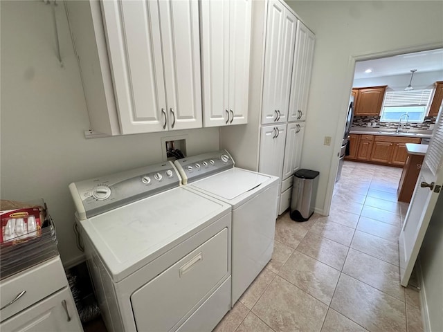 17483 SE 74th Netherclift Ter, The Villages, FL 32162 - washroom featuring cabinet space, washing machine and clothes dryer, and light tile patterned floors