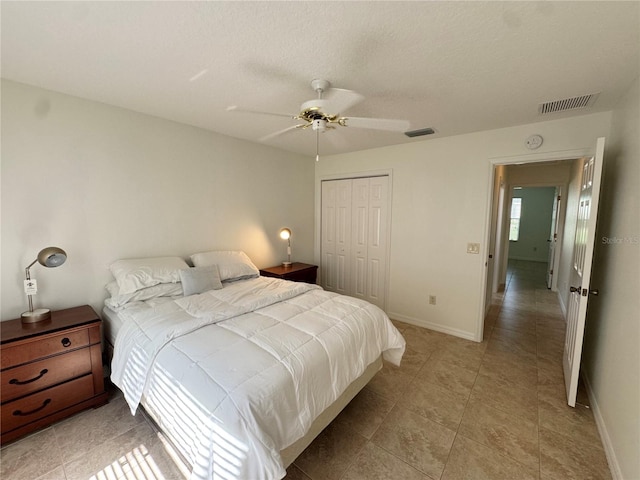 17483 SE 74th Netherclift Ter, The Villages, FL 32162 - bedroom with a closet, ceiling fan, and light tile patterned floors