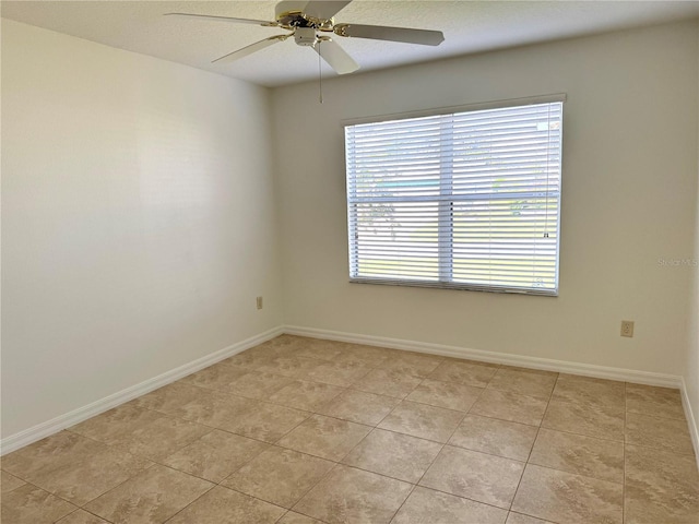 17483 SE 74th Netherclift Ter, The Villages, FL 32162 - empty room with healthy amount of natural light, a ceiling fan, and light tile patterned flooring